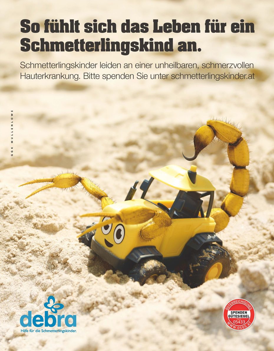 Kampagnensujet gelber Bagger im Sand