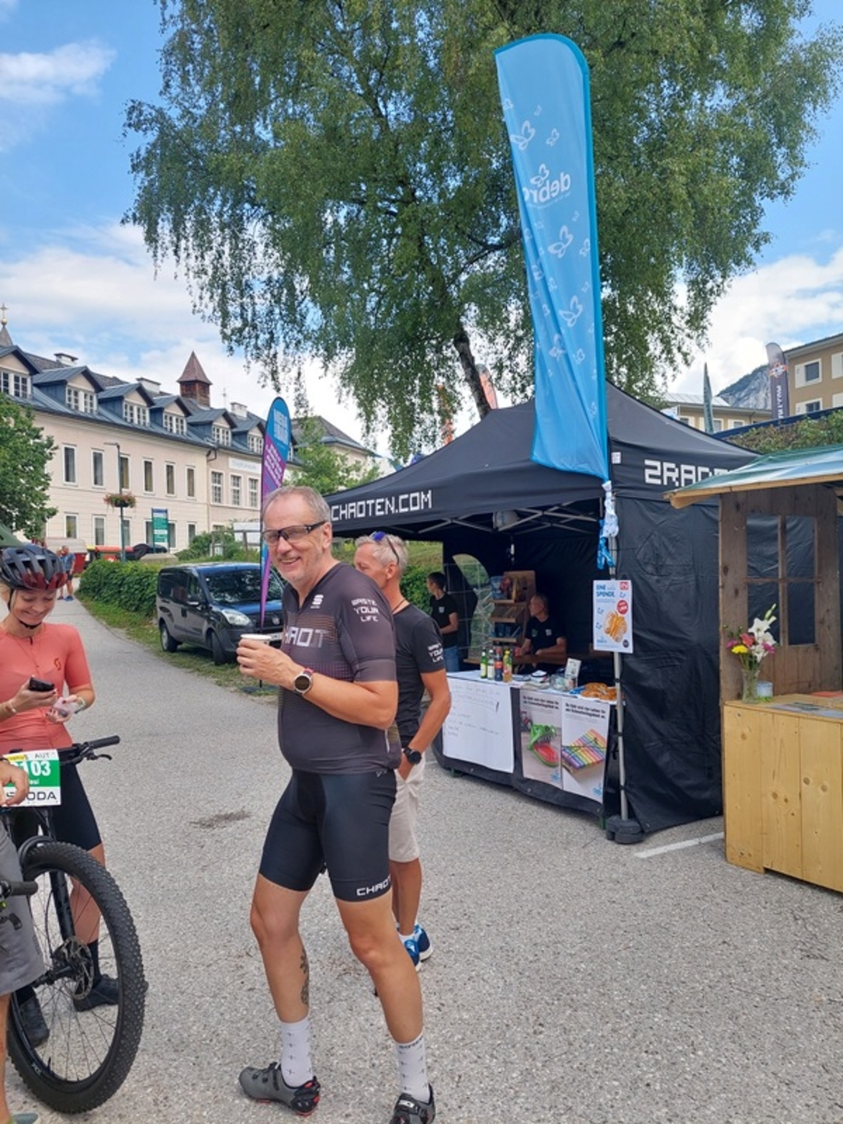 zwei Männer und eine Frau stehen vor dem DEBRA Austria Infostand