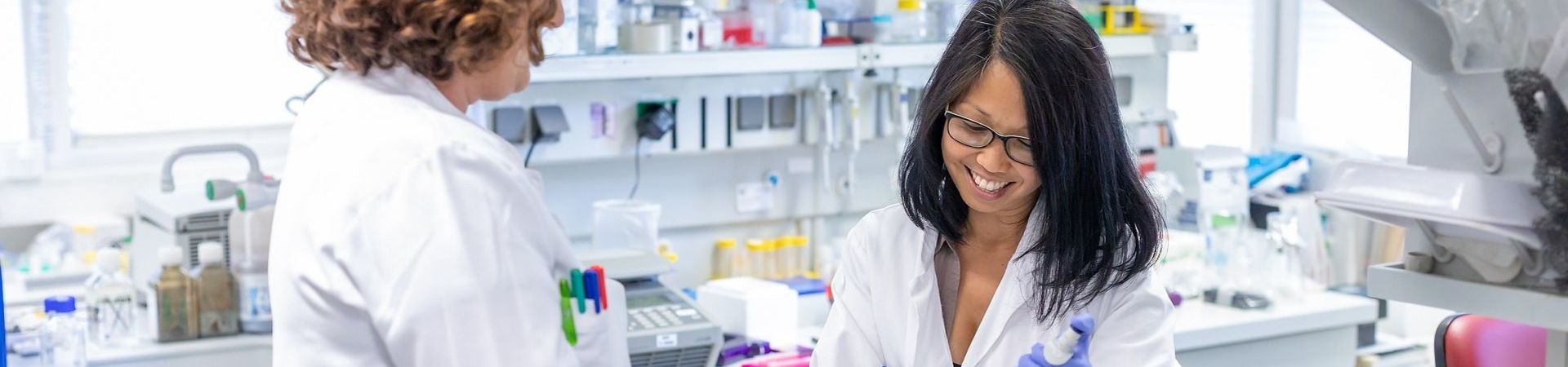 Two female EB researchers working in an EB lab